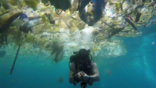 Diver makes a selfie from all the plastic that floats around him